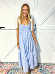 A different model wearing our chambray tiered dress with white ties for the sleeves