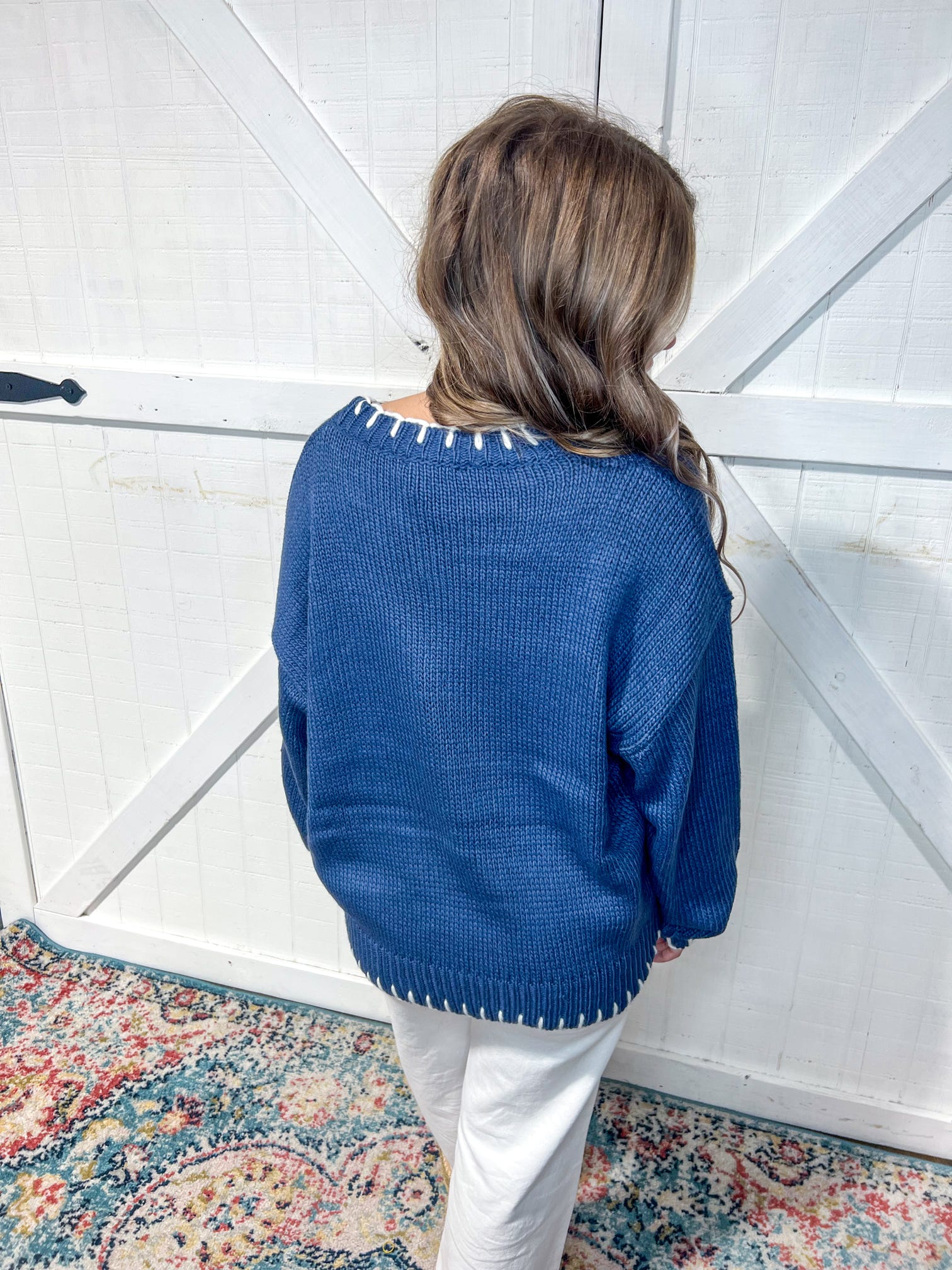 Photo of the back of our navy long sleeve sweater