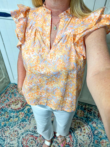 Up close photo of the baby blue blouse with yellow flowers all over