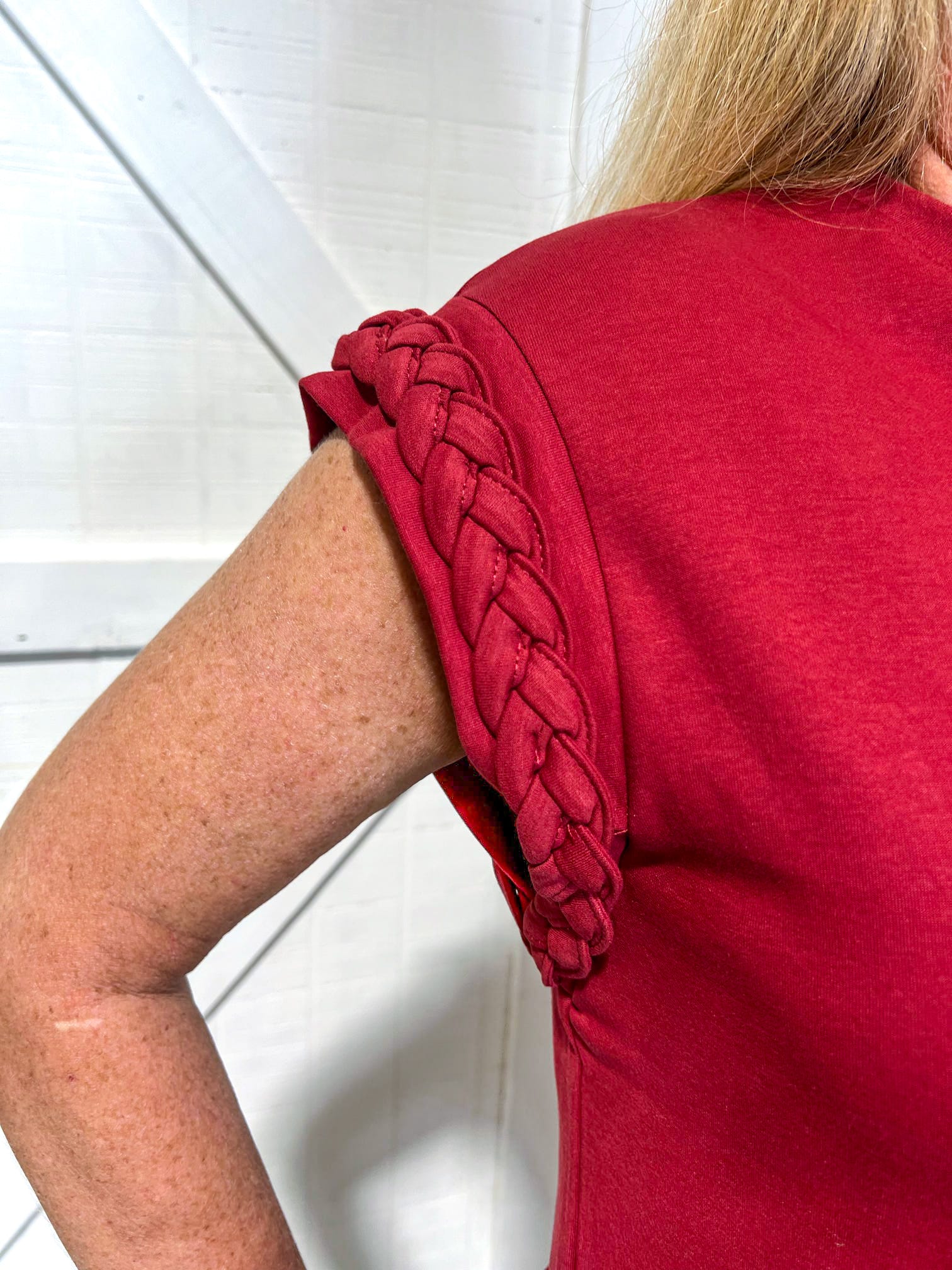 Up close photo of the burgundy braid on the sleeve