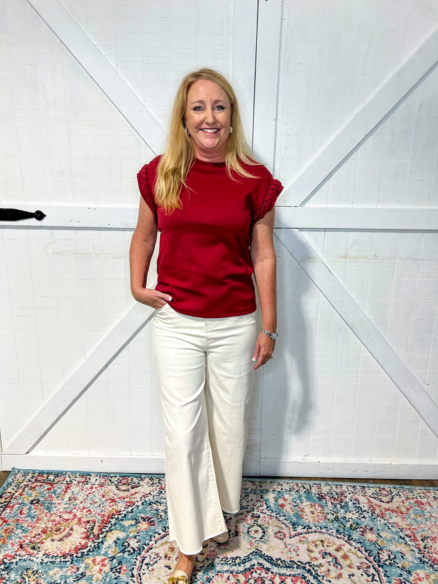 Mature woman modeling our Burgundy Braid Top. The cap sleeves have a braided material in the same burgundy color.