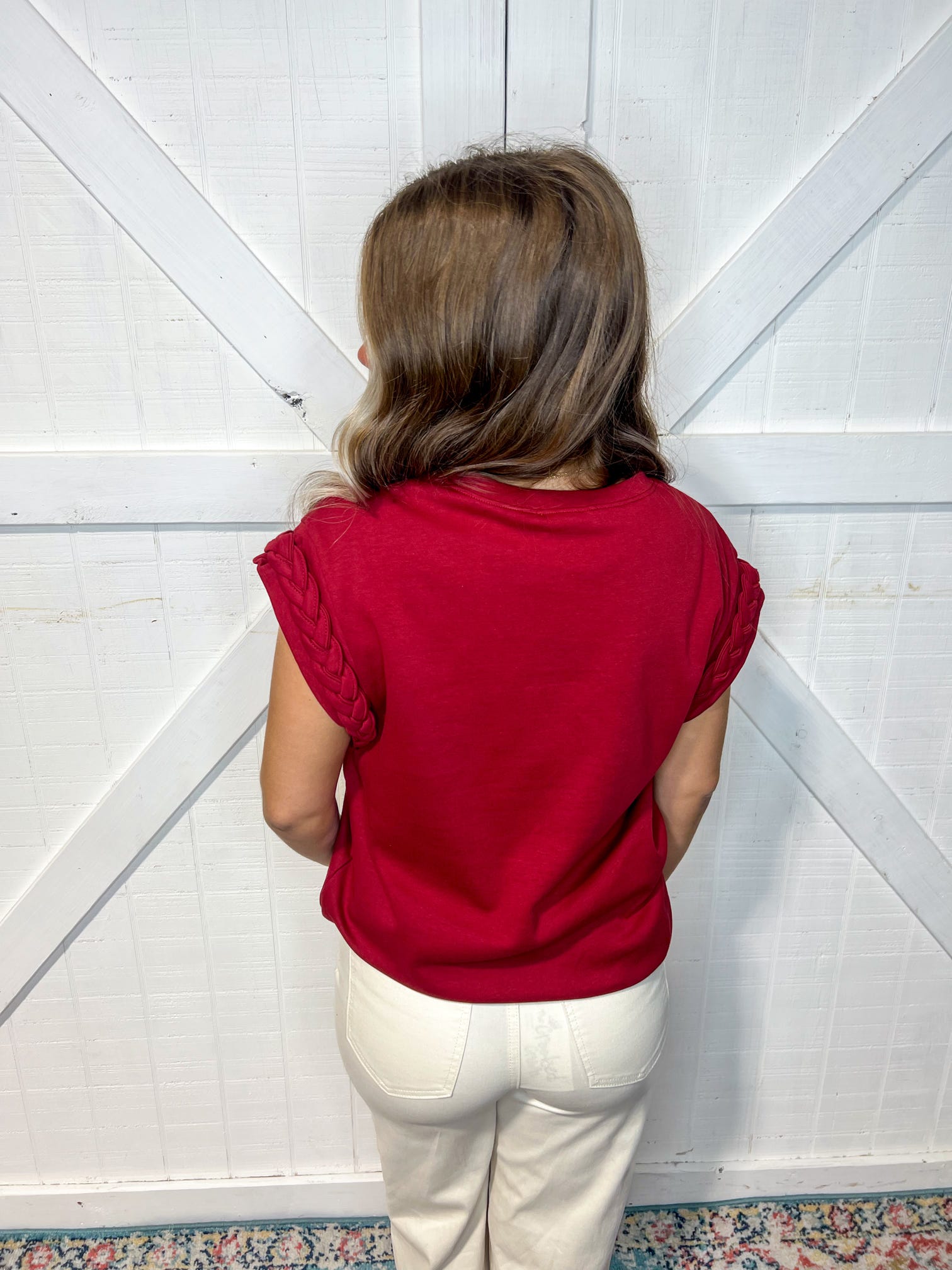 Photo of a woman modeling the back of this burgundy top.