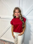 Photo of a young woman modeling our Burgundy Braid Top. The cap sleeves have a braided material in the same burgundy color.