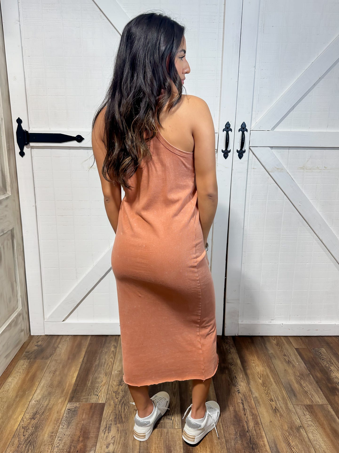 Photo of a woman modeling the back of our clay colored sleeveless maxi cotton dress