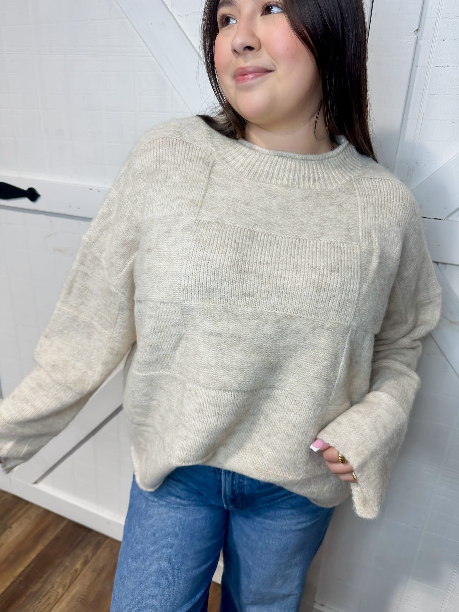 Up close photo of our cream long sleeve sweater with wide sleeves