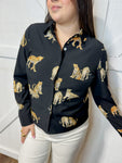 Young woman modeling our black, button down, long sleeve blouse with cheetah animals all over.