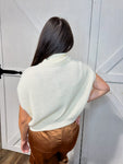 Photo of the back of our cream sweater top featuring cap sleeves and a short cowl neckline