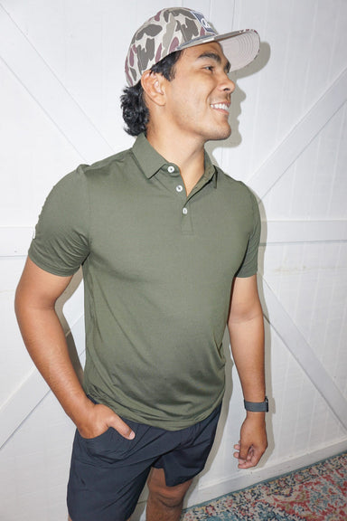 Man modeling a full view of our "mallard" green short sleeve, quick-dry, moisture wicking polo with UPF 50 protection.