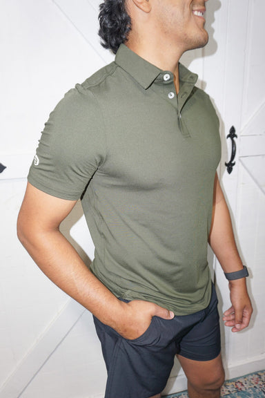 Man modeling a side view of our "mallard" green short sleeve, quick-dry, moisture wicking polo with UPF 50 protection.