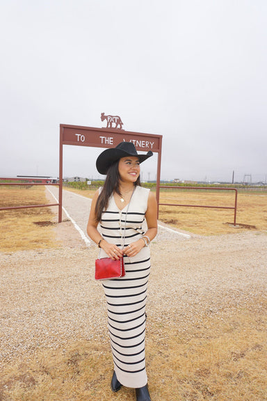 A girl modeling our cream and navy stripe two piece matching sleeveless "vest-looking" sleeveless top and skirt. 