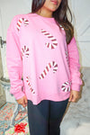 Up close photo of our bubblegum pink lightweight sweatshirt with big sequin candy canes all over the front.