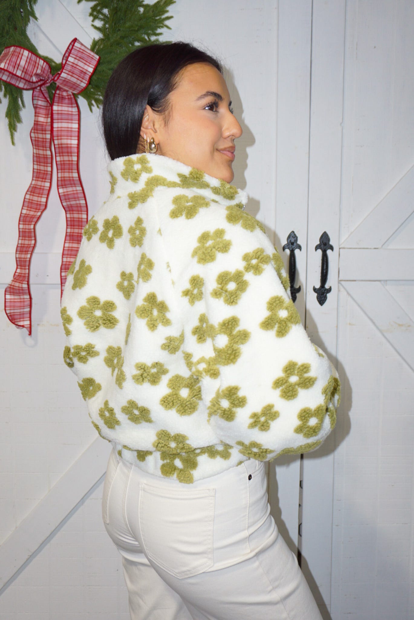 Photo of the back of our white with green daisies, fuzzy, zip-up jacket