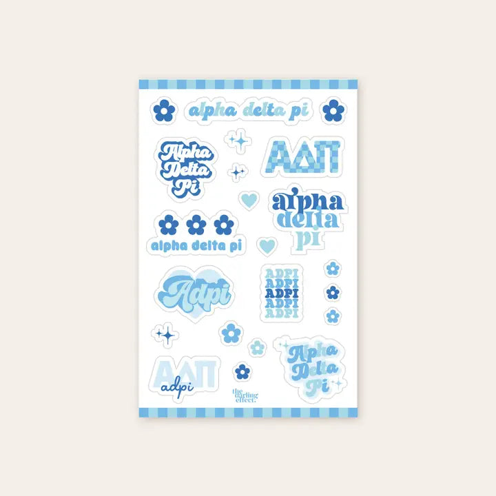 Up close photo showing a sheet of nine Alpha Delta Pi stickers along with 13 flowers and stars all in different shades of blue