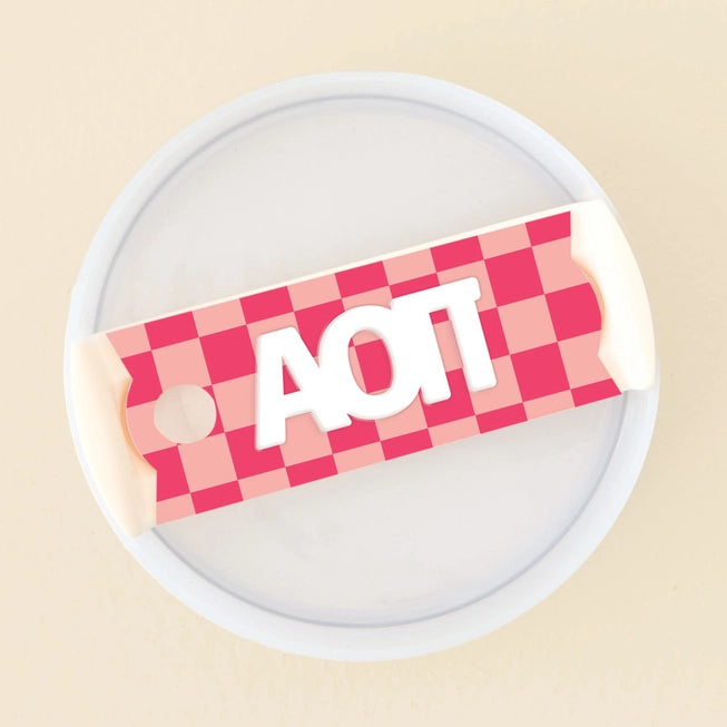 Photo showing the 40 oz tumbler lid up close. It has a pink checkered background and Alpha Omicron Pi written in greek letters in white on top