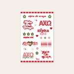 Up close photo showing a sheet of nine Alpha Chi Omega stickers along with 13 flowers and stars all in different shades of red and green