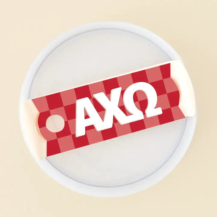 Photo showing the 40 oz tumbler lid up close. It has a red checkered background and Alpha Chi Omega written in greek letters in white on top