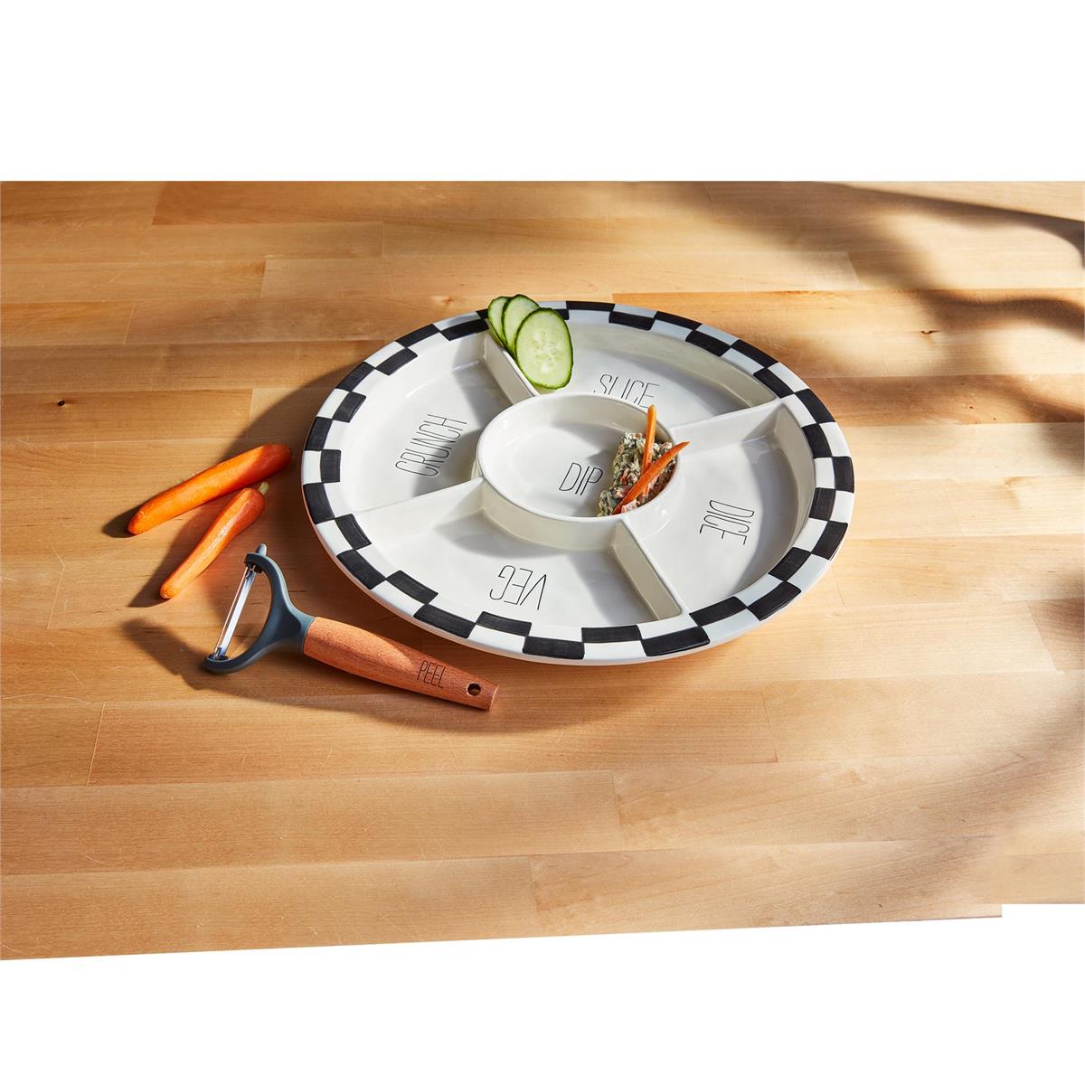 Photo of our black and white checkered crudite platter set that comes with a wood peeler. Each section of platter says something different: slice, dice, veg, crunch and dip. The photo has some different veggies on the platter to give an example.