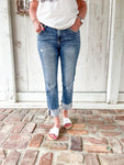 Another close up photo of just the jeans- a woman modeling a medium wash cropped jeans with very light distressing and a cuff at the bottom for the crop