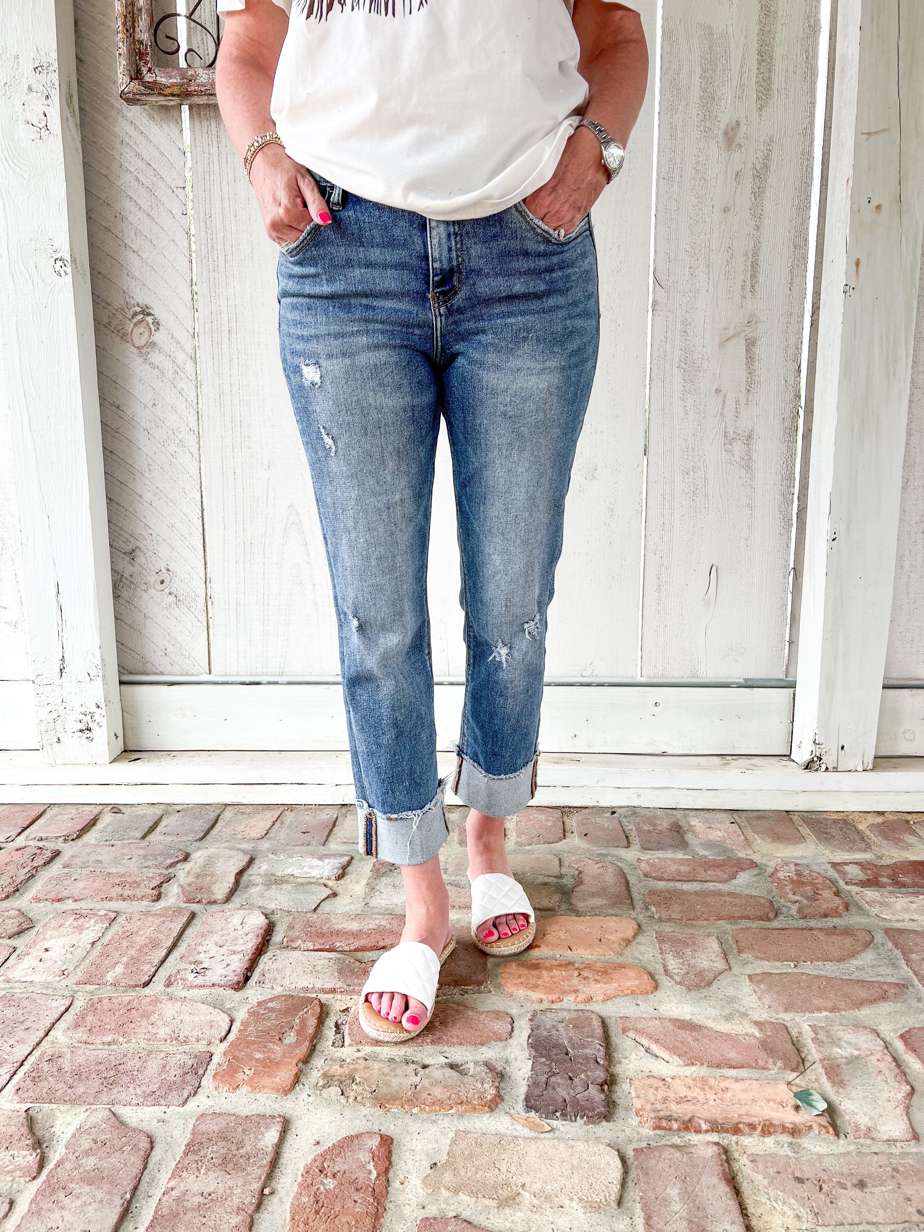 Another close up photo of just the jeans- a woman modeling a medium wash cropped jeans with very light distressing and a cuff at the bottom for the crop