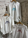 Another photo showing three different sorority sweatshirts on a white sweatshirt