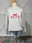 Up close photo of our AXO bow design on an Ash Grey sweatshirt