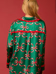 A woman modeling the back of these pj's with the all over red bow design and red satin trim