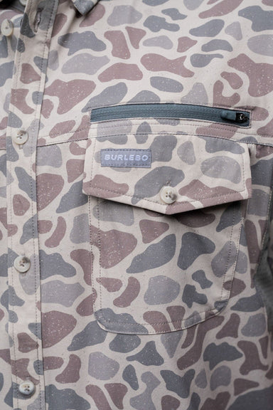 Up close photo of the deer camo print with a regular pocket on the chest along with an extra zipper pocket right above it on the right.