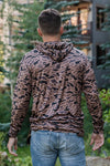 A man modeling the back of our gauge camo performance hoodie that is a quick-dry, moisture wicking, and has UPF 50 protection. Featuring anti-microbial technology, it keeps you fresh and odor-free